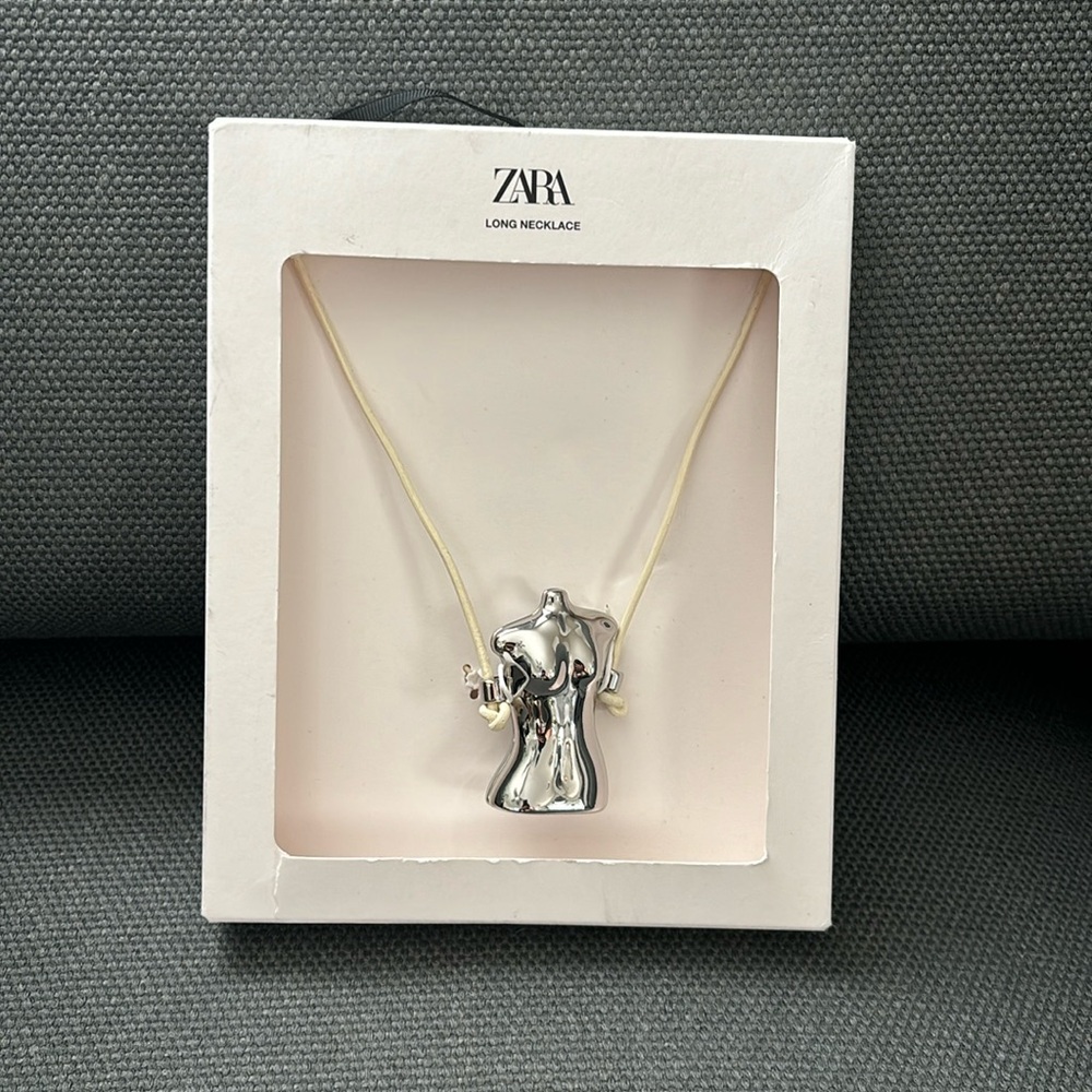 Zara long leather necklace with metal bust charm